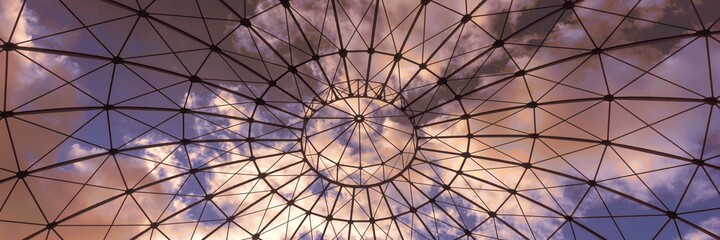 Bottom view of an iron structure with sky and clouds in the sunset. Panoramic image