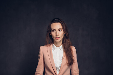 Worried adult caucasian woman on dark background