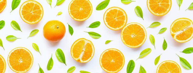 Obraz na płótnie Canvas High vitamin C, Juicy and sweet. Fresh orange fruit with green leaves on white.