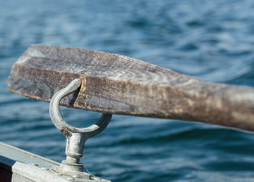 Wooden oar in a aluminum rowlock