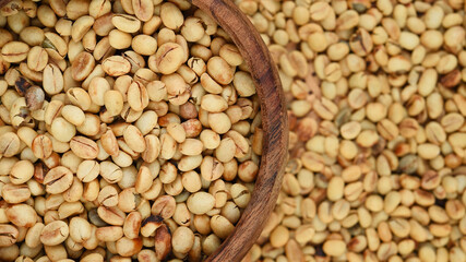 Close up of coffee beans in wooden bowl for background