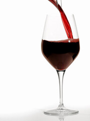 Pouring Red Wine in a Glass on white Background - Isolated