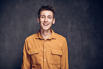 Happy young caucasian man on dark background