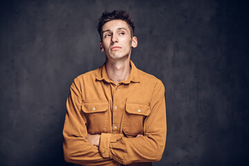 Pensive young caucasian man on dark background