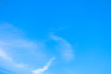 thin white clouds against a background of bright blue sky