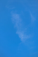 thin white clouds against a background of bright blue sky