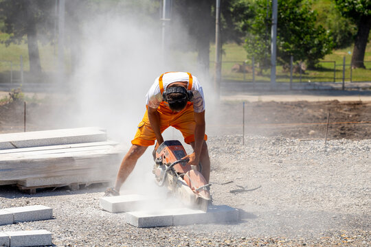 Worker Cutting Granit Stone With Circular Hand Saw