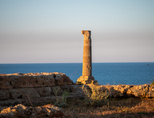 archaeological park of Capo Colonna at sunset, column of the Temple of Hera Lacinia on the Ionian Sea. Capo Rizzuto, Crotone, Calabria, Italy.