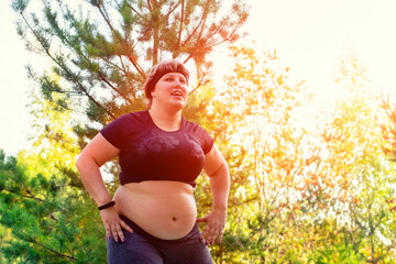 Plus size female model in sports uniform is engaged in sports. Positive oversized young caucasian woman in nature.