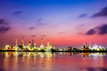 Fototapeta na wymiar Bangchak Oil Refinery, a view of oil refinery along Chaopraya river at sunrise with reflection in the water, Bangkok, Thailand