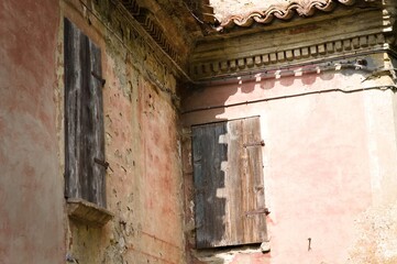 Wooden ruined windows in a an old building with wooden shutters (Fiorenzuola di Focara, Pesaro, Italy, Europe)