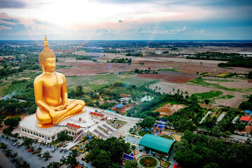 Naklejka premium Aerial view of big golden buddha statue in Wat Muang, Angthong province in Thailand.