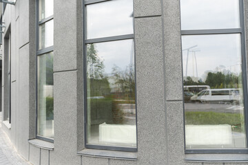 Abstract fragment of modern architecture, gray walls, glass and concrete.