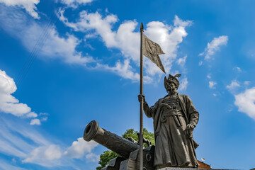Kharkiv, Ukraine - July 20, 2020: The bronze statue of the great otaman Ivan Sirko in Kharkov against a blue cloudy sky closeup. Zaporizhzhia Army’s outstanding military leader monument with a cannon
