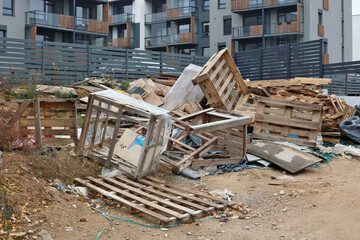 Wooden boards and planks  at the garbage dump near the apartment building
