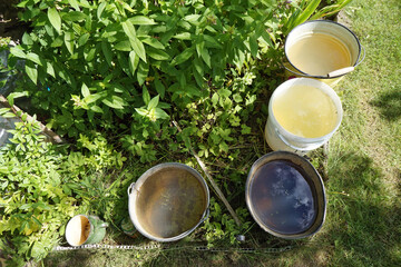 Hot  summer day and dirty  water in buckets in  garden