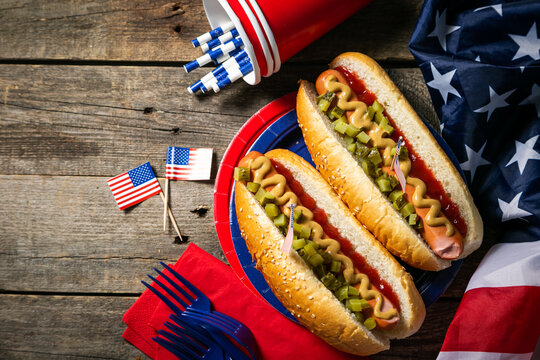USA national holiday Labor Day, Memorial Day, Flag Day, 4th of July - hot dogs with ketchup and mustard on wood background, copy space