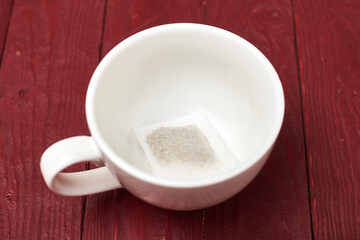 Fototapeta na wymiar Tea bag in a white cup. Preparation for making tea.