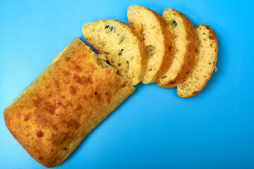 Sliced ciabatta on a blue background.