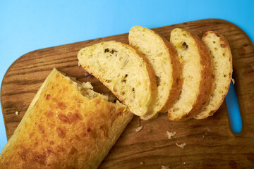 Sliced ciabatta on a blue background.
