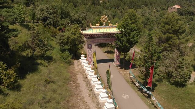 Aerial View of the Entrance Gate of the Buddhist Temple Dag Shang Kagyu and Prayer Flags