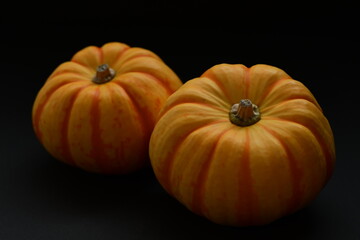 Fresh orange pumpkins isolated on black background.