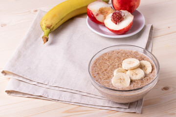 a portion of morning granola porridge served on rustic wooden surface