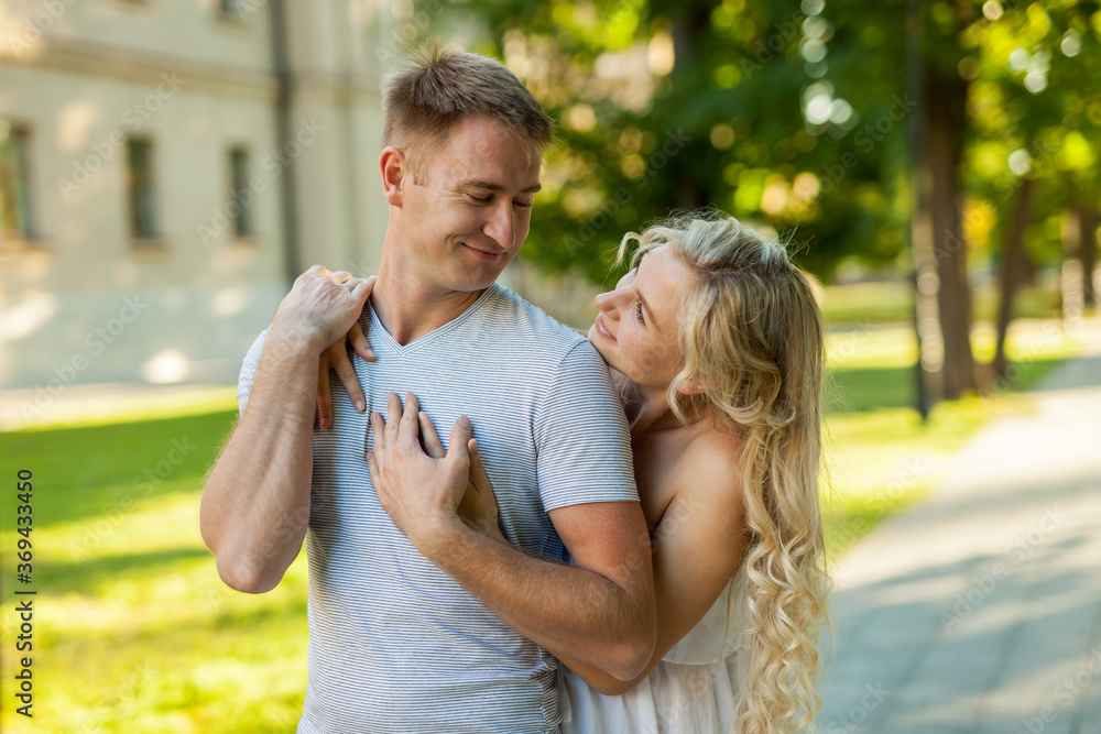 Wall mural portrait of beautiful young loving couple smiling outdoors