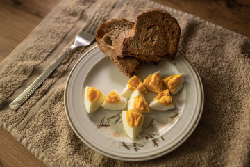Closeup of white plate with hard boiled eggs. Breakfast food