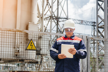 The energy engineer inspects the equipment of the substation. Power engineering. Industry