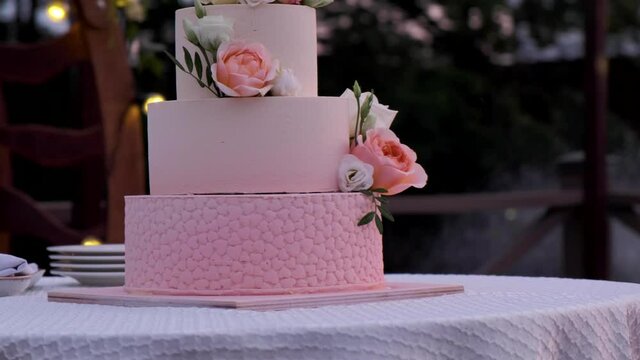 pink big cake. Three-tiered wedding cake.