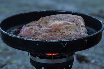 Frying food outdoors with camping kitchen gear, using gas and hiking frying pan