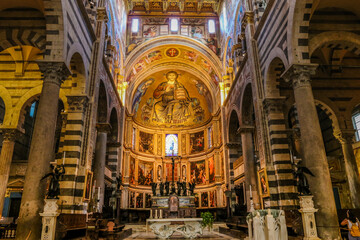 Fototapeta premium In front of the altar inside the beautiful Pisa Cathedral (Duomo di Pisa) with the impressive mosaic of Christ in Majesty, in the apse, flanked by the Blessed Virgin and St. John the Evangelist. 