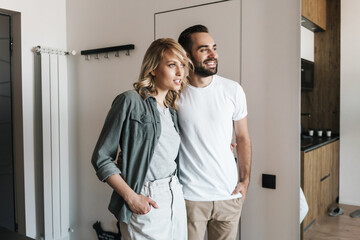 Loving couple standing together indoors at home