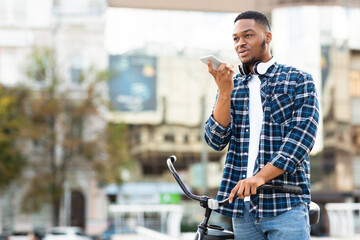 Portrait of black man talking on phone using speaker