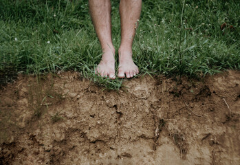 A barefoot man standing on the ground