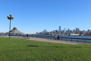 View Manhattan Skyline - Hoboken, New Jersey - Green area, empty park, with blue sky - Maxwell Place Park