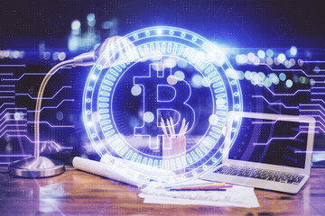 Double exposure of blockchain and crypto economy theme hologram and table with computer background....
