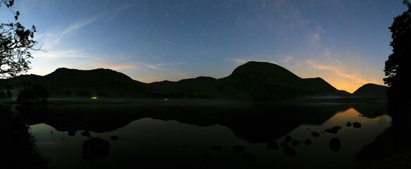 A Panoramic view of Brotherswater with a mist on the water & a faint Milky way.
