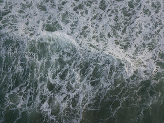 Fototapeta premium Aerial photo of a small surf break off the coast of New Zealand. 