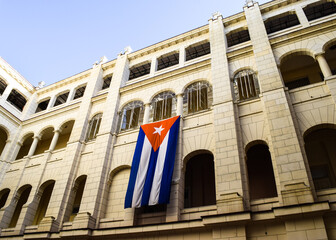 HAVANA, CUBA - MARCH 8, 2017: Bottom-up view of the building of Revolution Museum from its inner courtyard. There is a cuban flag hanging from the wall.