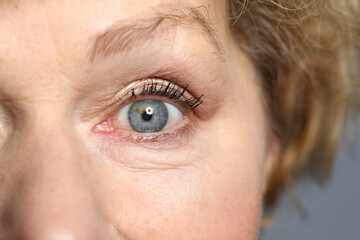 Obraz premium Blue eyes of an elderly woman. Healthy complexion and aging skin