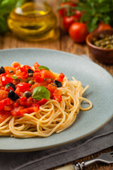 Italian spaghetti alla Pultanesca with tomatoes and olives. Served without meat and cheese.