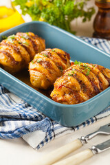 Baked potatoes in Swedish. Hasselback. Stuffed with cheese and bacon. Top view.