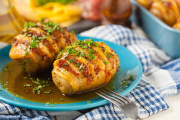 Baked potatoes in Swedish. Hasselback. Stuffed with cheese and bacon. Top view.