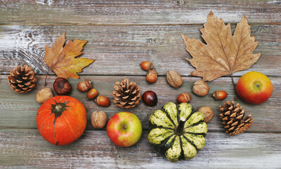 Autumn background.  Autumn leaves,cups, and pumpkin on wooden background.