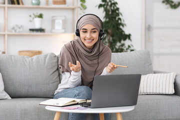Online Tutoring. Young muslim woman teacher having video call with students