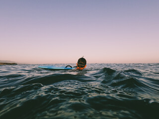 A young boy learning in body board outdoors in the shoreline in a sunny day of summer
