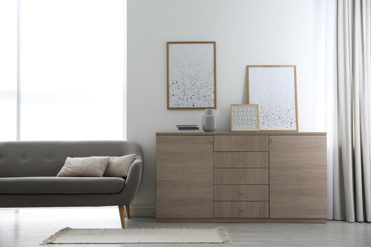 Modern room interior with stylish chest of drawers