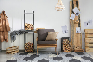Stylish room interior with firewood as decorative element